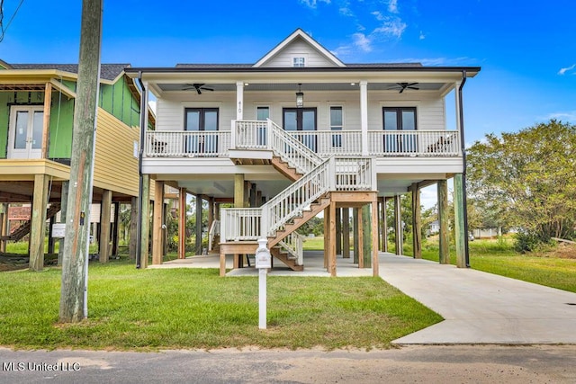 raised beach house featuring a carport, ceiling fan, a porch, and french doors