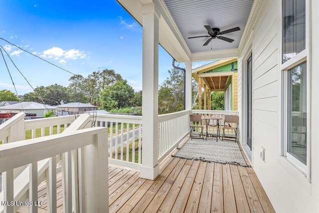 wooden terrace featuring ceiling fan