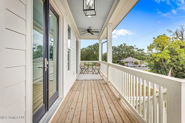 deck with french doors and ceiling fan