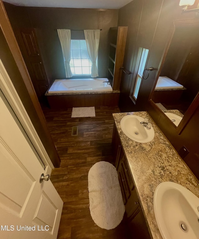43 White Oak Dr, Natchez, MS 39120 - bathroom with double vanity, wood finished floors, and a bath