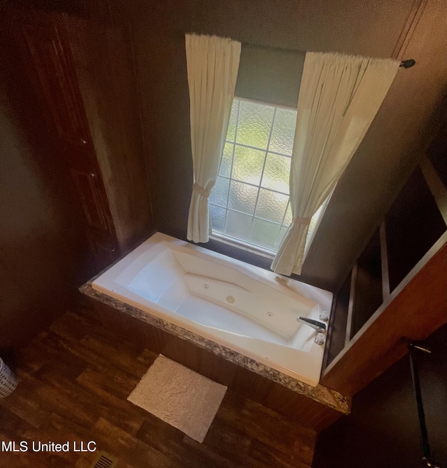 43 White Oak Dr, Natchez, MS 39120 - full bathroom featuring a tub with jets and wood finished floors