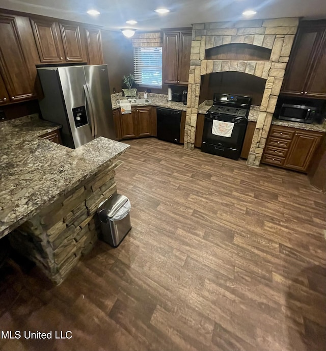 43 White Oak Dr, Natchez, MS 39120 - kitchen with black appliances, light stone counters, dark wood-type flooring, and extractor fan