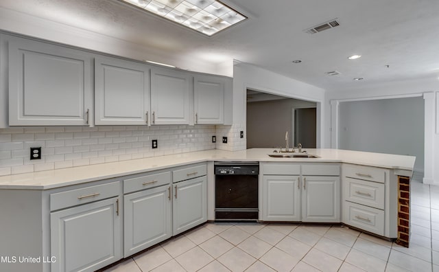 354 Lakeway Dr, Brandon, MS 39047 - kitchen with dishwasher, a sink, a peninsula, light tile patterned flooring, and backsplash
