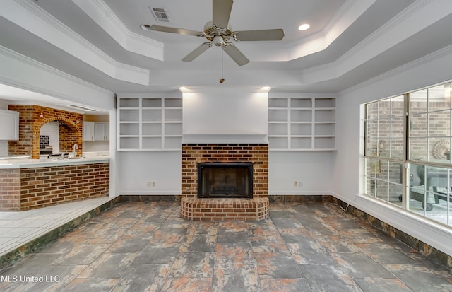 354 Lakeway Dr, Brandon, MS 39047 - unfurnished living room with a fireplace, ornamental molding, a tray ceiling, baseboards, and a ceiling fan
