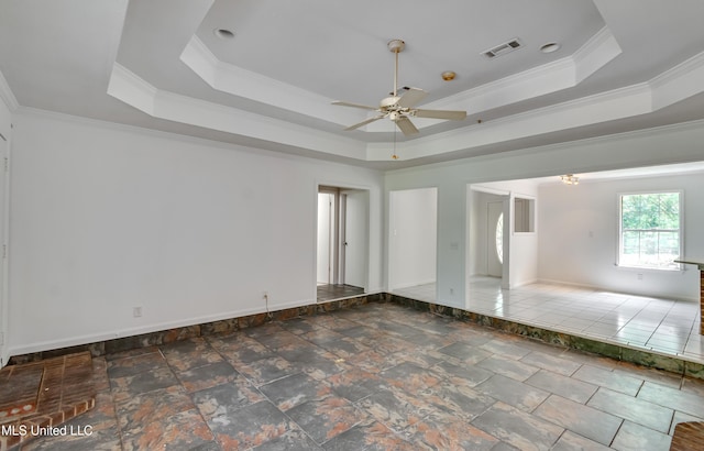354 Lakeway Dr, Brandon, MS 39047 - spare room featuring a raised ceiling, a ceiling fan, crown molding, stone finish flooring, and baseboards