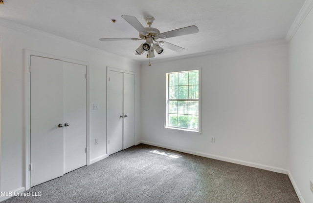 354 Lakeway Dr, Brandon, MS 39047 - unfurnished bedroom with carpet floors, two closets, ornamental molding, baseboards, and ceiling fan