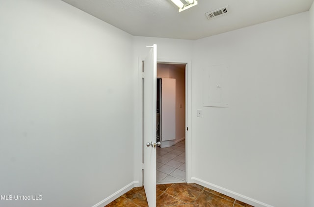 354 Lakeway Dr, Brandon, MS 39047 - spare room with dark tile patterned floors, baseboards, and electric panel