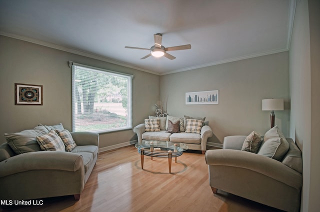 living room featuring ornamental molding, light hardwood / wood-style flooring, and ceiling fan