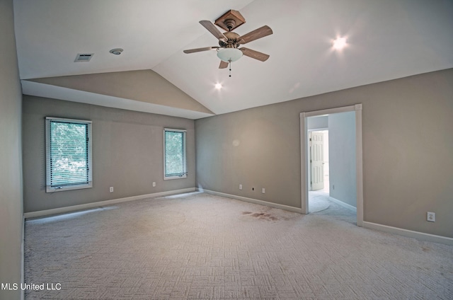 empty room with light carpet, lofted ceiling, and ceiling fan