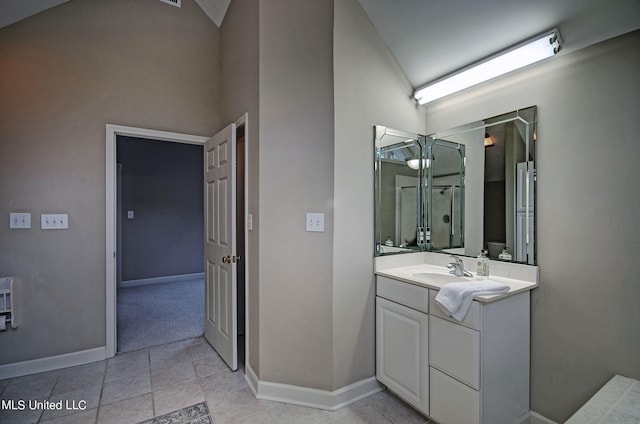 bathroom with vanity, tile patterned flooring, and vaulted ceiling