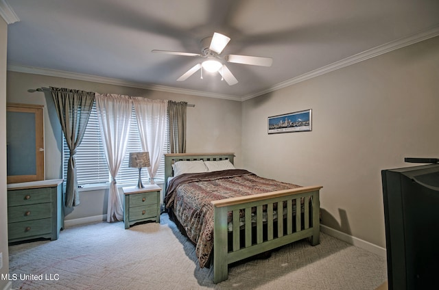 carpeted bedroom with ceiling fan and ornamental molding