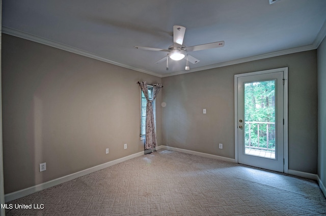 carpeted spare room with crown molding and ceiling fan