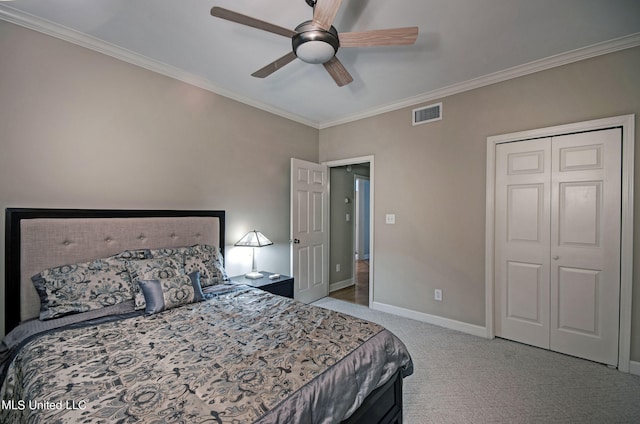 carpeted bedroom featuring a closet, ceiling fan, and crown molding