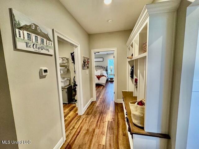 mudroom featuring a wall mounted AC and wood-type flooring