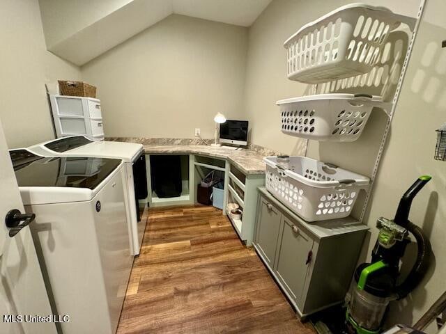 kitchen featuring vaulted ceiling, dark hardwood / wood-style floors, and separate washer and dryer