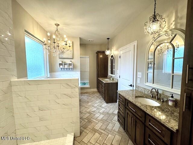 bathroom with vanity and a chandelier