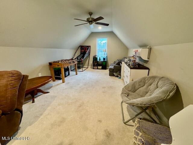 interior space featuring light carpet, lofted ceiling, and ceiling fan