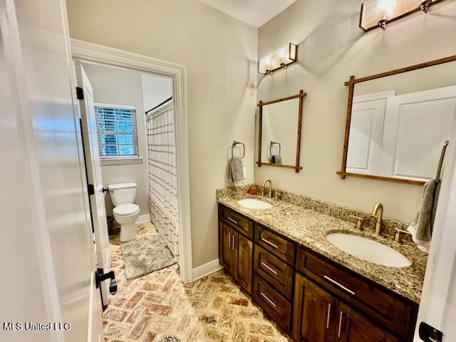 bathroom featuring toilet and vanity