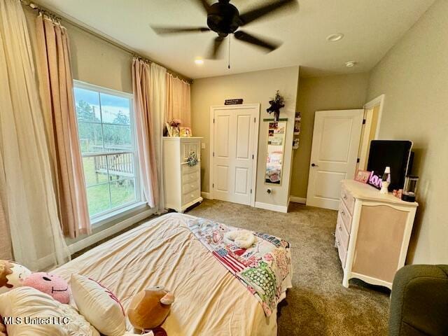 bedroom featuring ceiling fan and light colored carpet