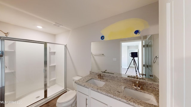 bathroom featuring wood-type flooring, vanity, toilet, and walk in shower