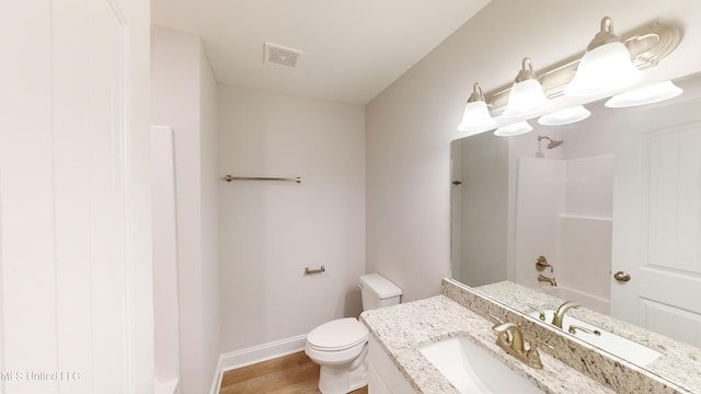 full bathroom featuring shower / tub combination, vanity, wood-type flooring, and toilet