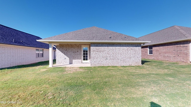 rear view of property featuring a patio area and a yard