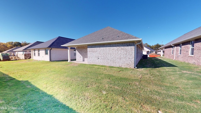 rear view of house featuring a lawn