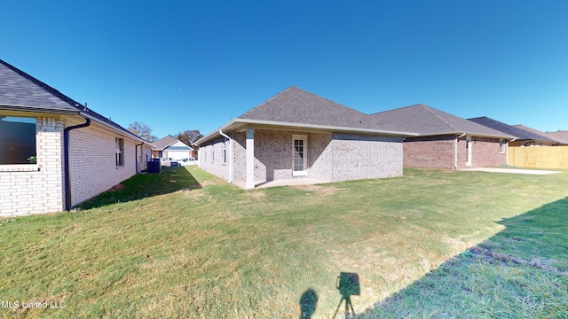 rear view of house with a lawn