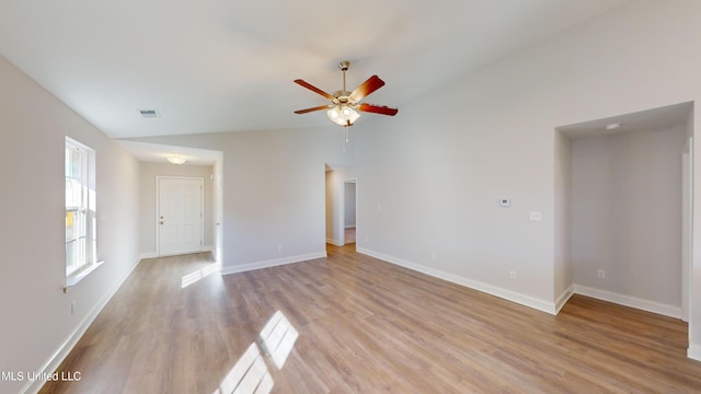 unfurnished living room featuring ceiling fan, light hardwood / wood-style flooring, and vaulted ceiling