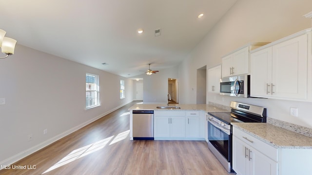 kitchen with white cabinetry, ceiling fan, light wood-type flooring, and appliances with stainless steel finishes