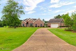 123 Munich Dr, Madison, MS 39110 - traditional home featuring a front lawn, driveway, and an attached garage