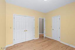 123 Munich Dr, Madison, MS 39110 - unfurnished bedroom with wood finished floors and baseboards
