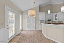 123 Munich Dr, Madison, MS 39110 - kitchen with vaulted ceiling, white appliances, and pendant lighting