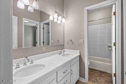 123 Munich Dr, Madison, MS 39110 - bathroom with double vanity, a chandelier, and shower / bathtub combination