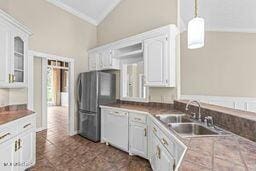 123 Munich Dr, Madison, MS 39110 - kitchen featuring dishwasher, a sink, white cabinets, freestanding refrigerator, and glass insert cabinets