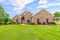 123 Munich Dr, Madison, MS 39110 - view of front facade with a front lawn and stone siding