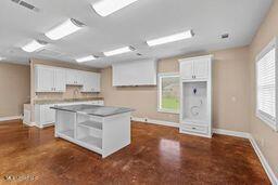123 Munich Dr, Madison, MS 39110 - kitchen with white cabinetry, open shelves, and baseboards