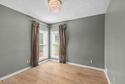 123 Munich Dr, Madison, MS 39110 - empty room with baseboards and wood finished floors