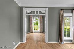 123 Munich Dr, Madison, MS 39110 - foyer entrance featuring baseboards, plenty of natural light, ornamental molding, and wood finished floors