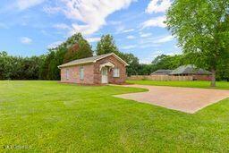 123 Munich Dr, Madison, MS 39110 - view of green lawn with an outbuilding