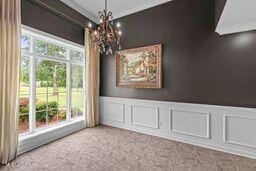 123 Munich Dr, Madison, MS 39110 - unfurnished dining area featuring a decorative wall, a chandelier, wainscoting, and ornamental molding