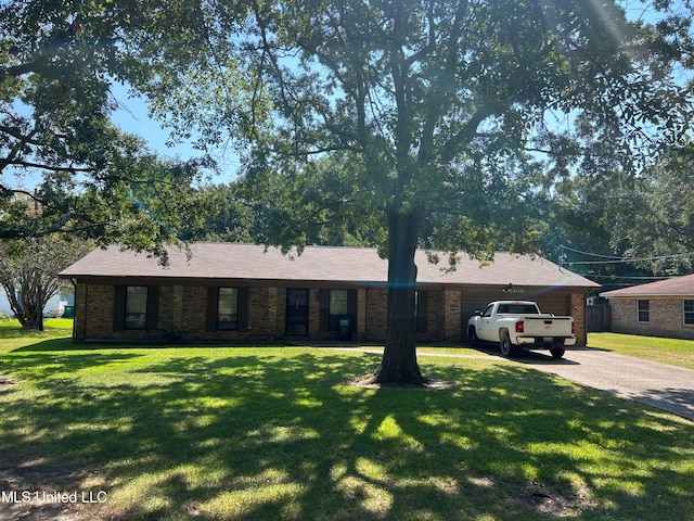 ranch-style house with a garage and a front lawn