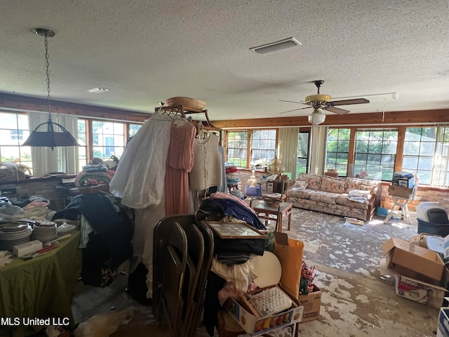 misc room featuring ceiling fan and a textured ceiling