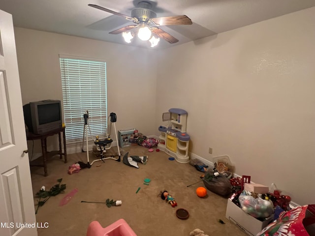 misc room with ceiling fan and carpet