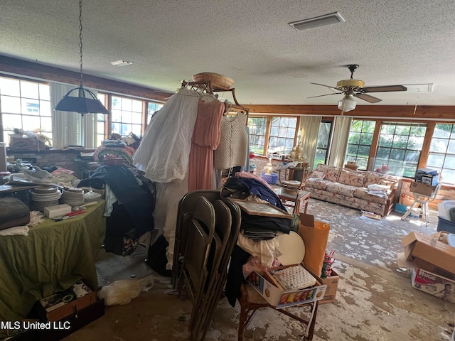 miscellaneous room featuring ceiling fan and a textured ceiling