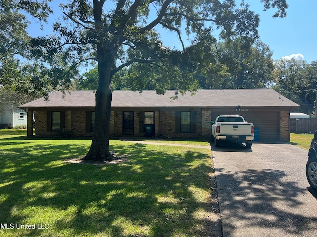 ranch-style home featuring a front lawn and a garage