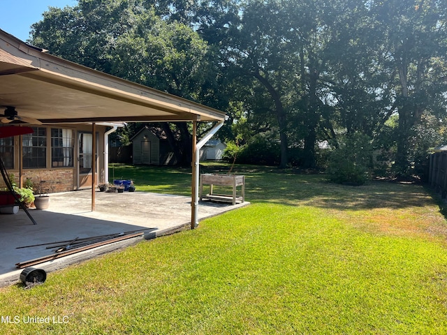 view of yard with a patio area and ceiling fan