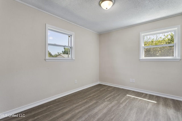 empty room featuring a textured ceiling, ornamental molding, baseboards, and dark wood-type flooring