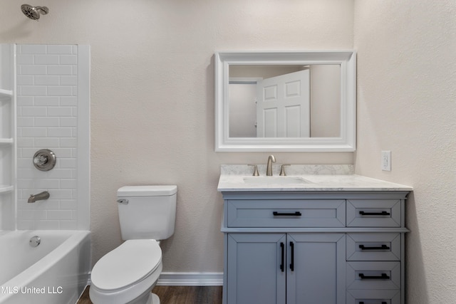 bathroom with washtub / shower combination, vanity, toilet, baseboards, and wood finished floors