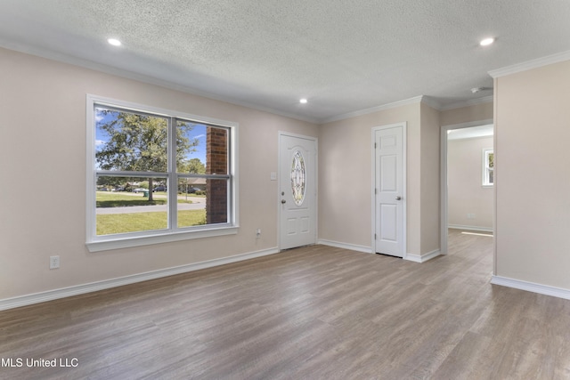 interior space with recessed lighting, a textured ceiling, ornamental molding, and wood finished floors